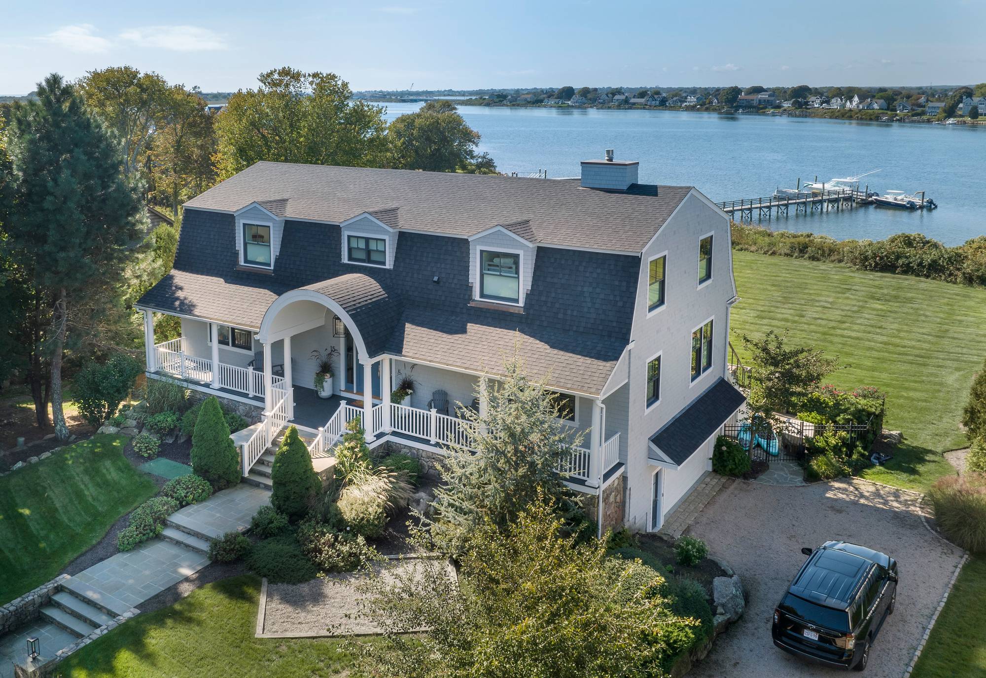 Rhode Island Residence — aerial view of the coastal home, dock, and cove