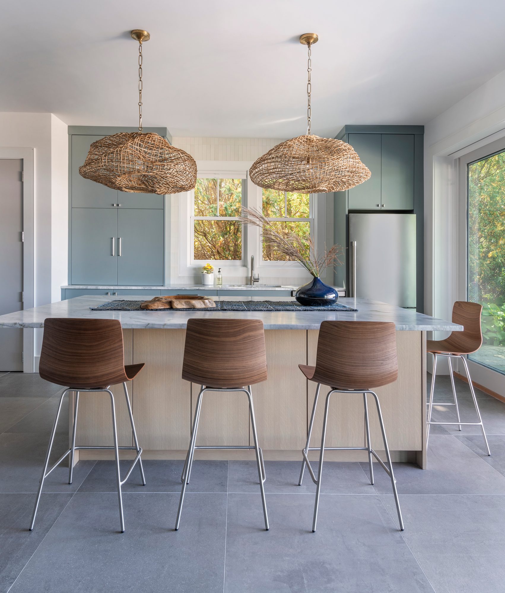 Rhode Island Residence — kitchen island with woven pendants and walnut stools