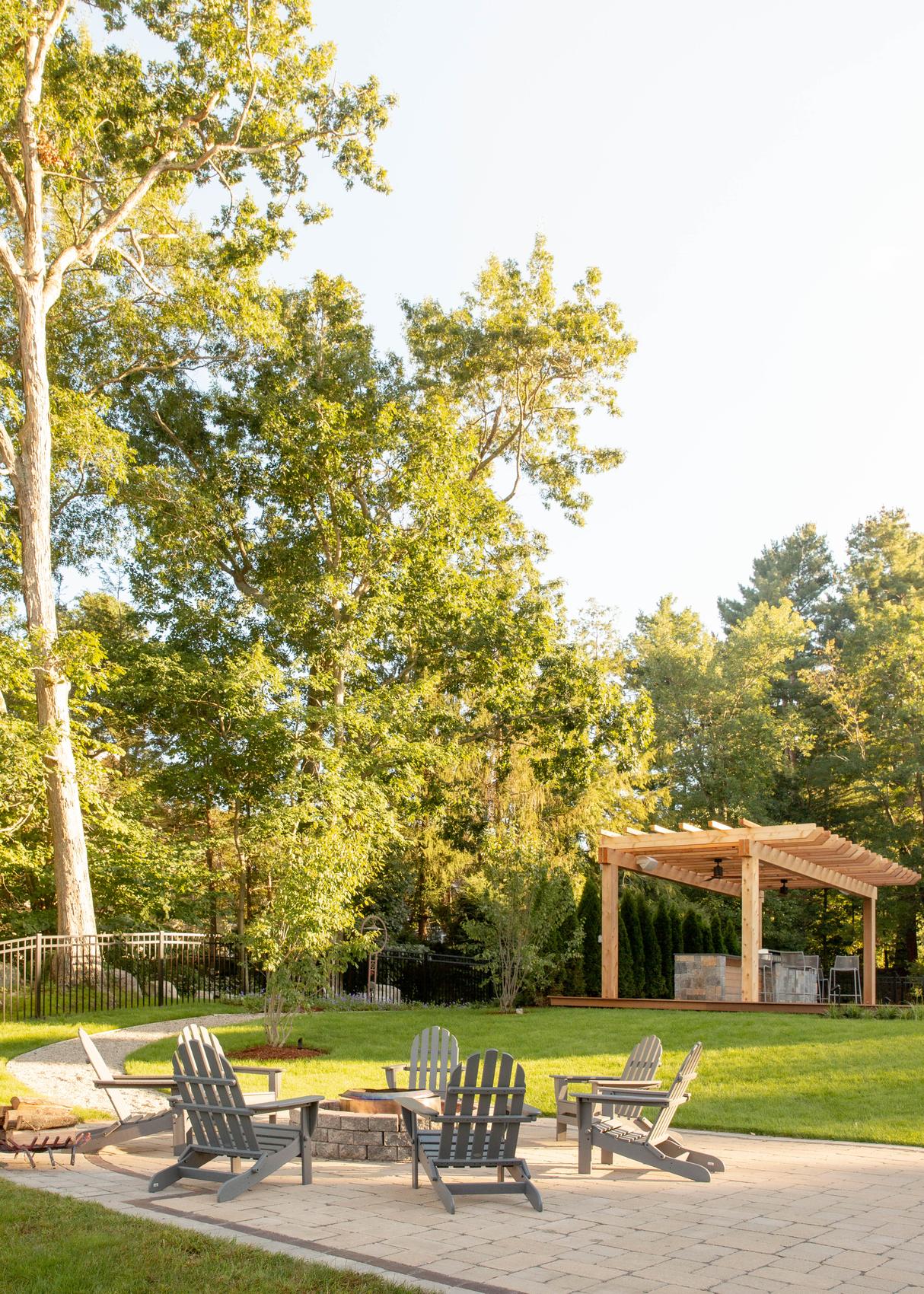 Sharon Landscape — fire-pit lounge with Adirondack chairs on the paver patio