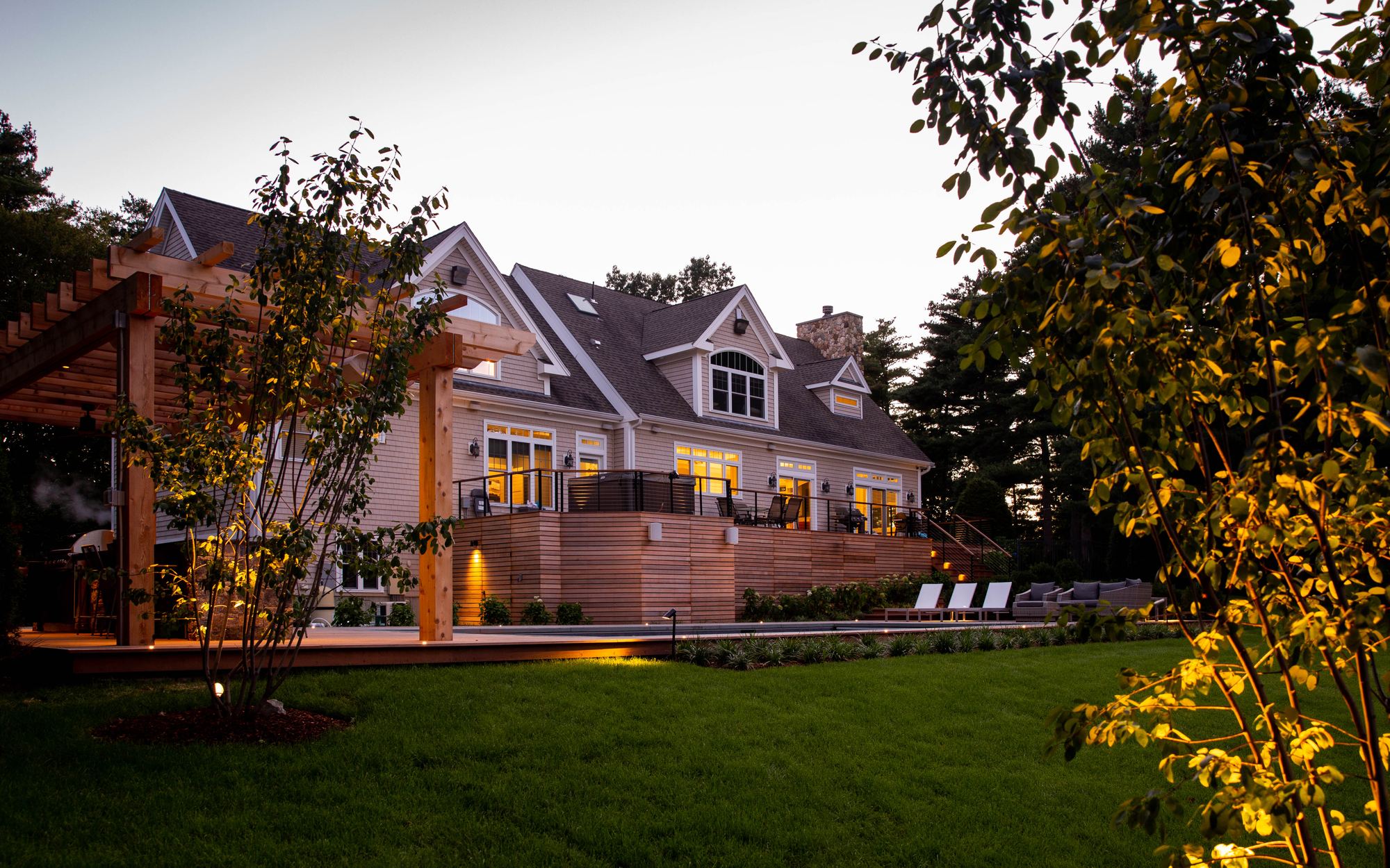 Sharon Landscape — twilight view of the pergola, ipe deck wall, and pool lighting