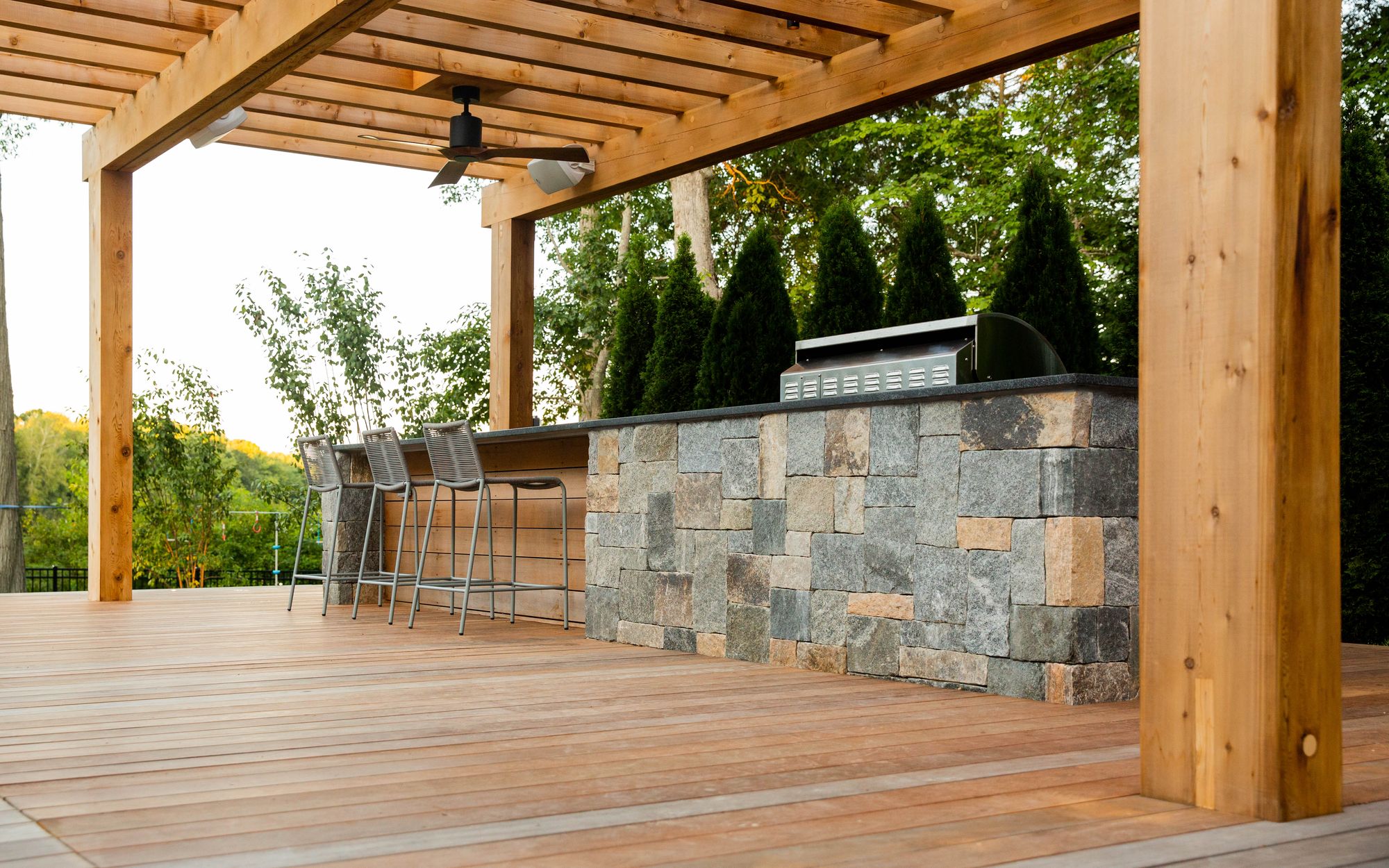 Sharon Landscape — under the cedar pergola along the stone-veneer bar and ipe decking