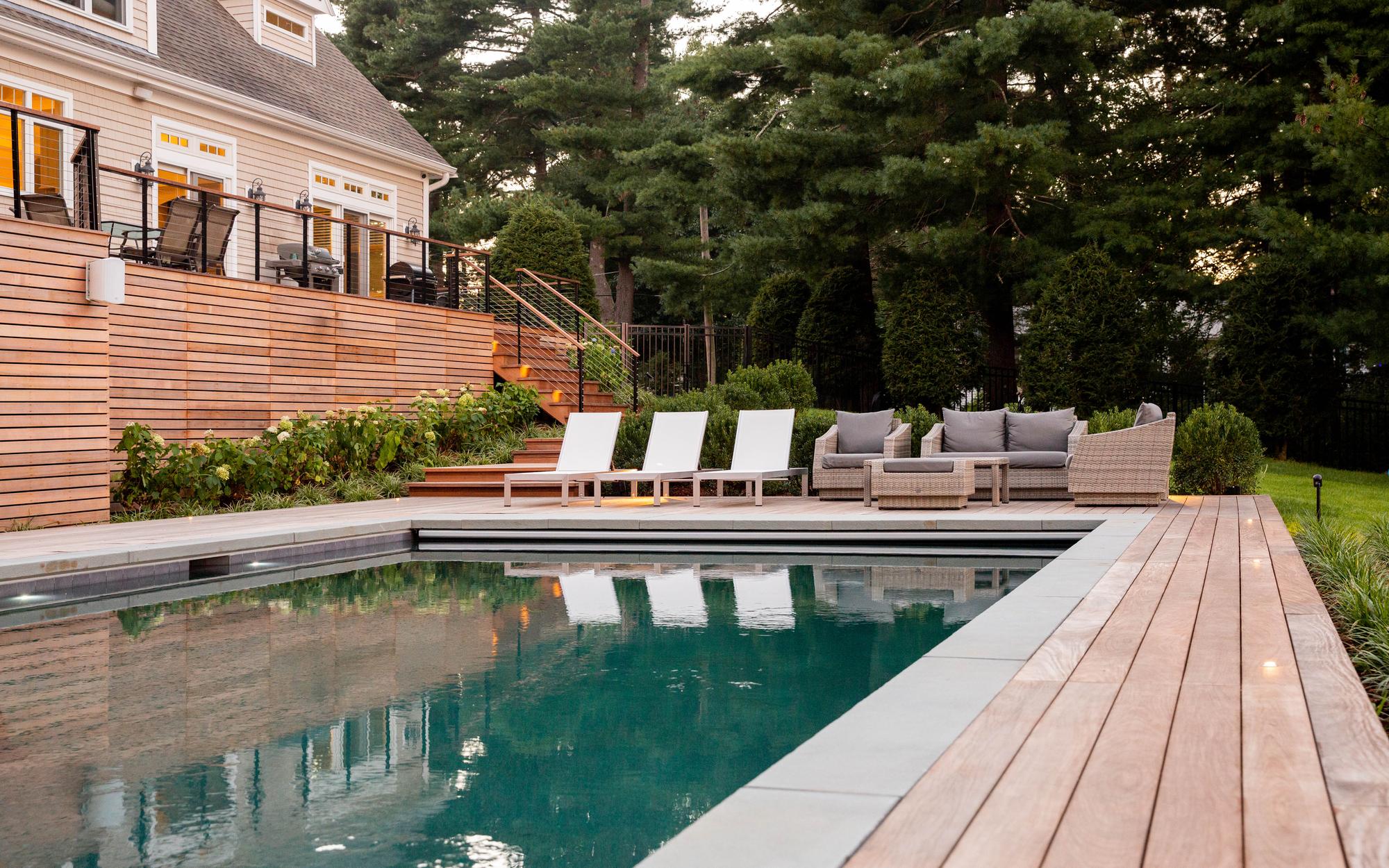 Sharon Landscape — golden-hour poolside with mirror-smooth reflection