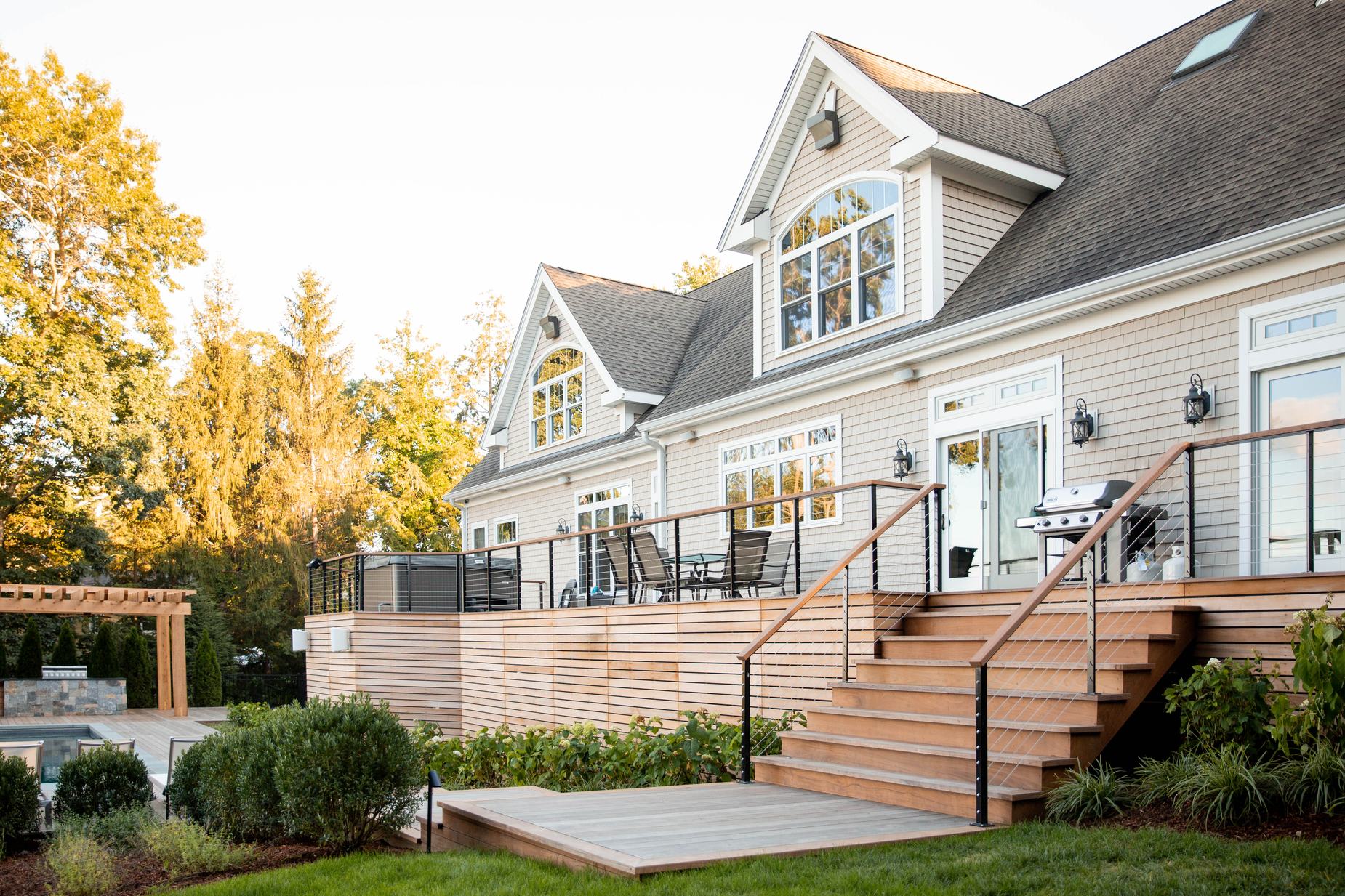 Sharon Landscape — rear elevation of the home with cable-rail deck and plantings