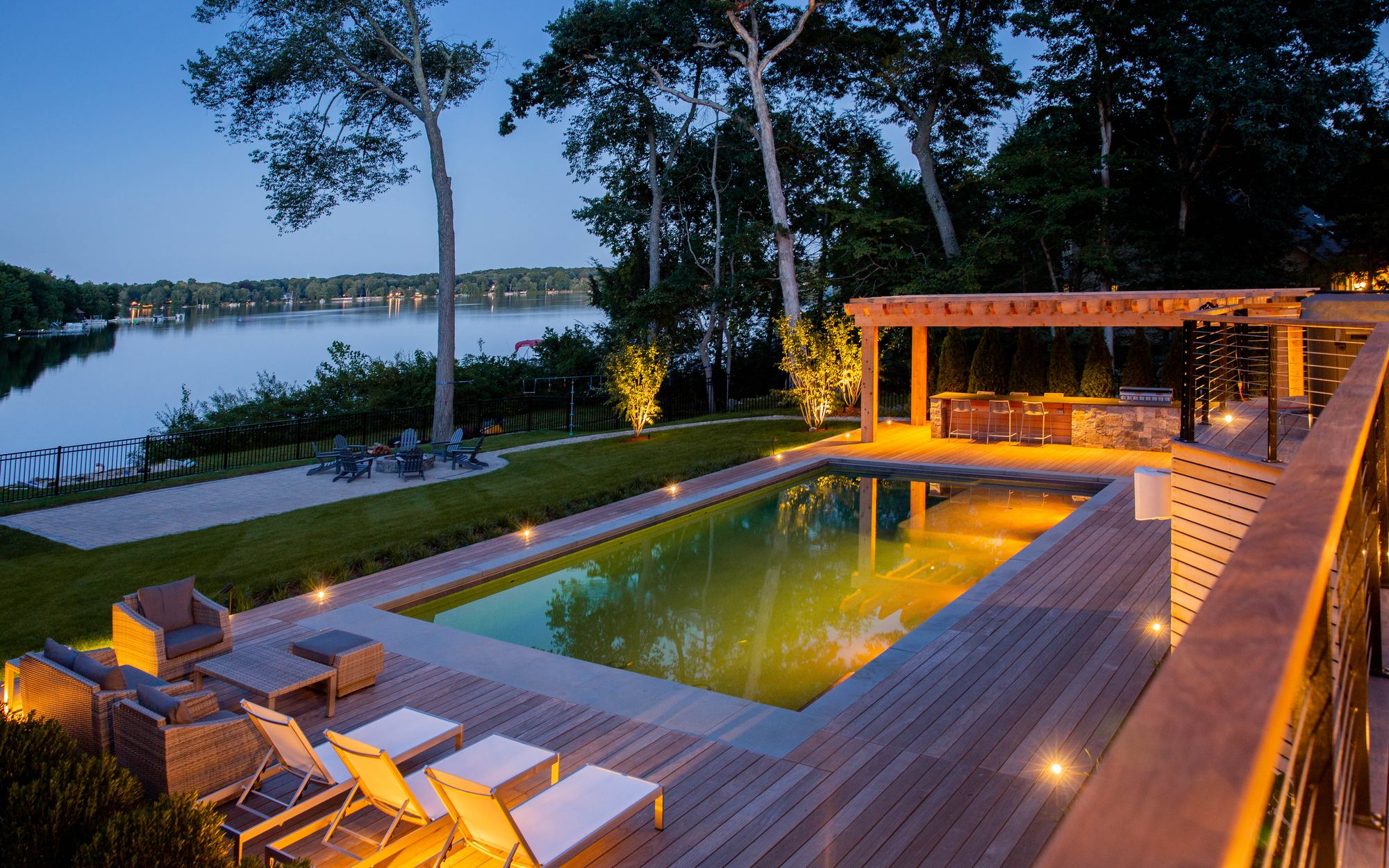 Sharon Landscape — twilight view of the lit pergola, pool, and lake