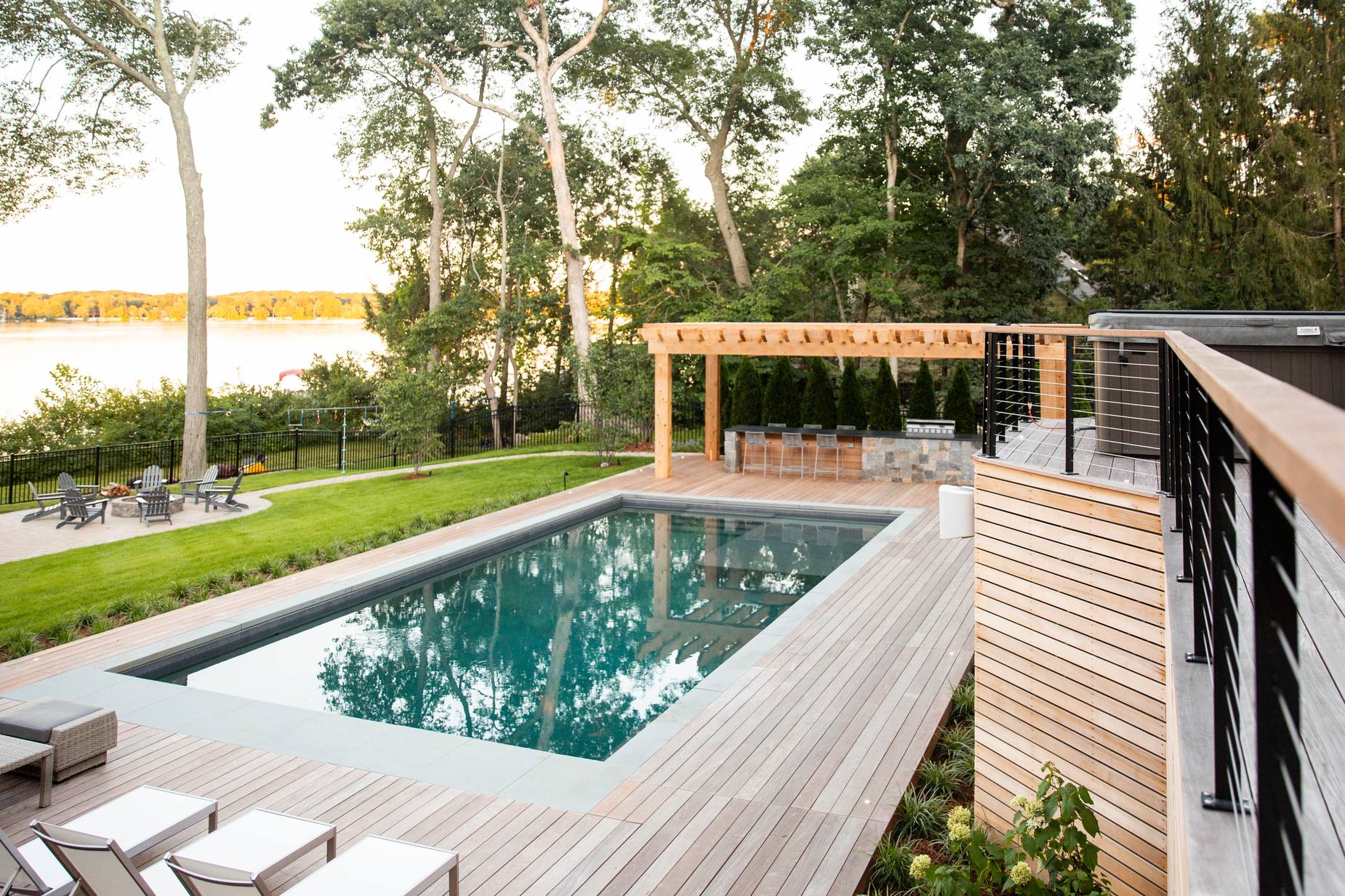 Sharon Landscape — wide view of the pool, pergola, lawn, and lake