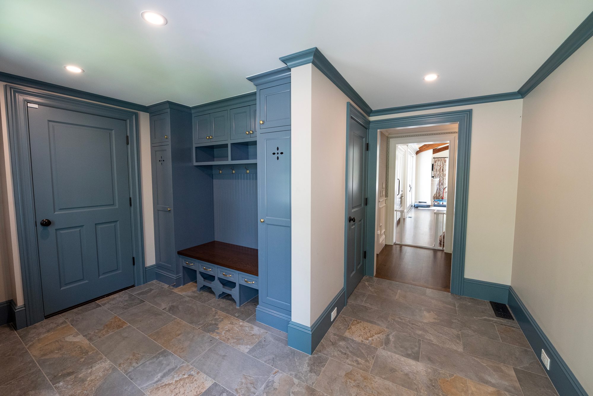 Wellesley Renovation — custom mudroom built-ins with bench, cubbies, and stone floor