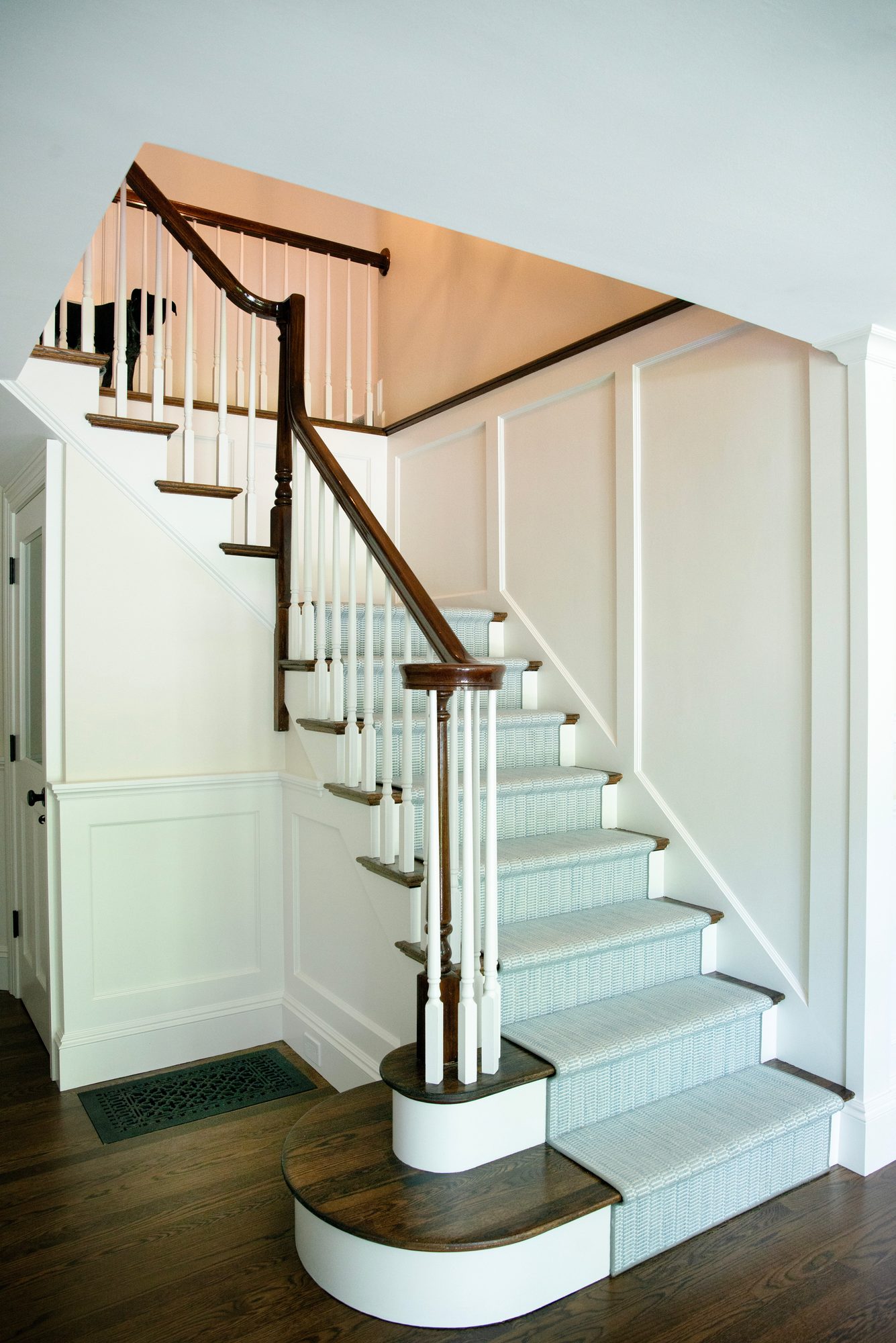 Wellesley Renovation — main staircase with wood treads and a patterned runner