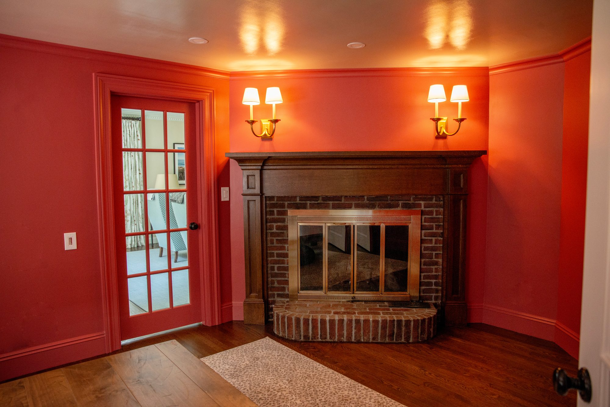 Wellesley Renovation — family room fireplace beside a glazed door to the adjoining room