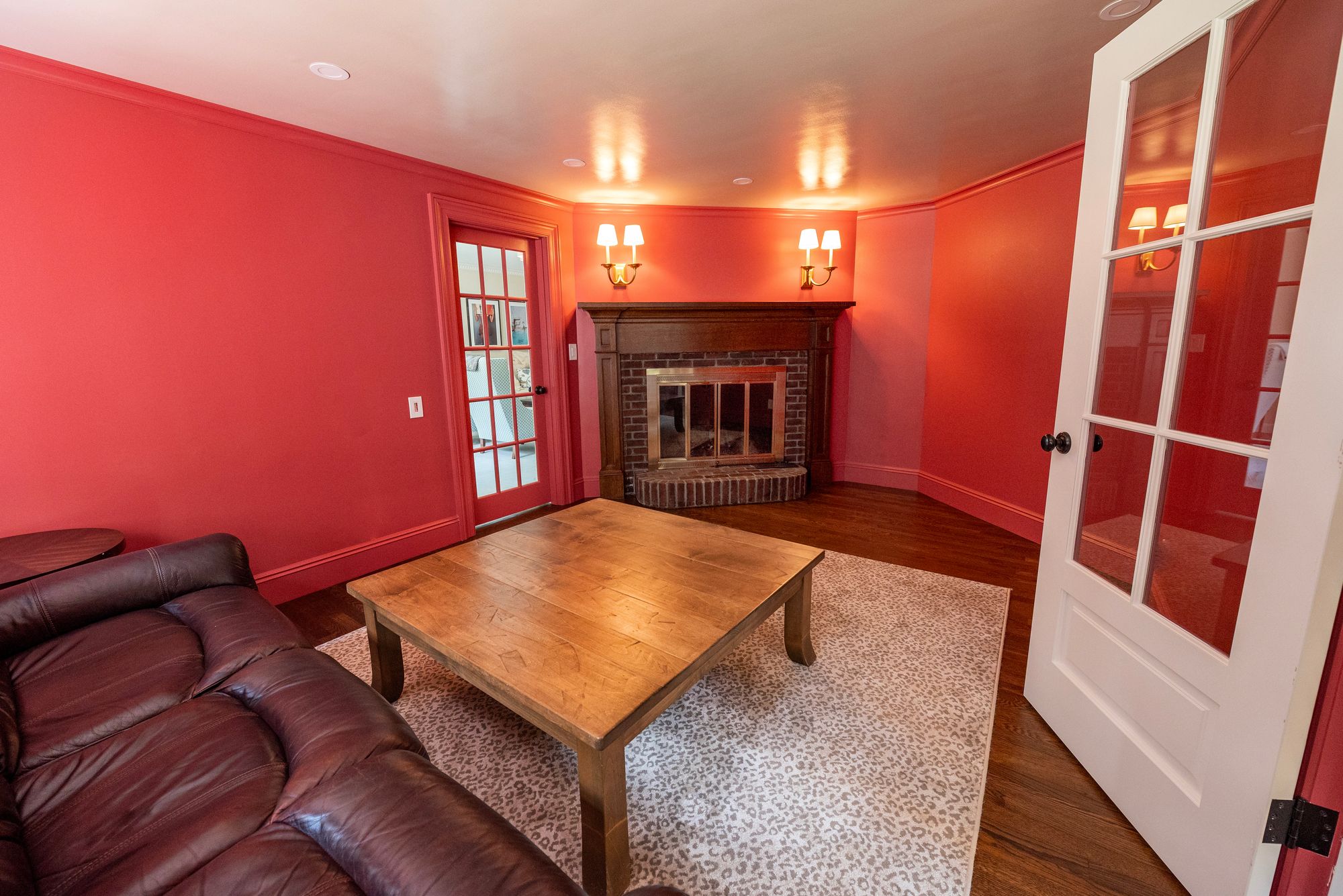 Wellesley Renovation — family living room with brick fireplace and French doors