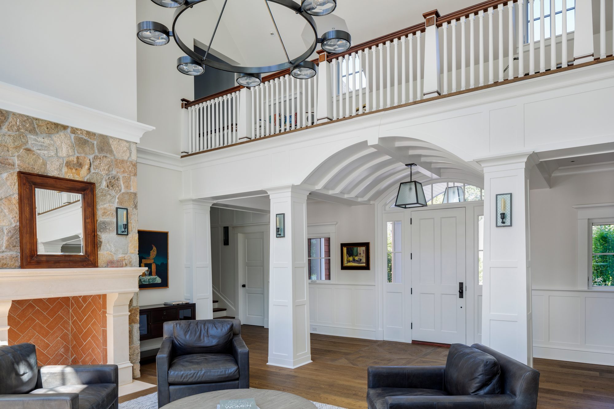 Weston Residence — double-height great room with stone fireplace and barrel-vaulted ceiling