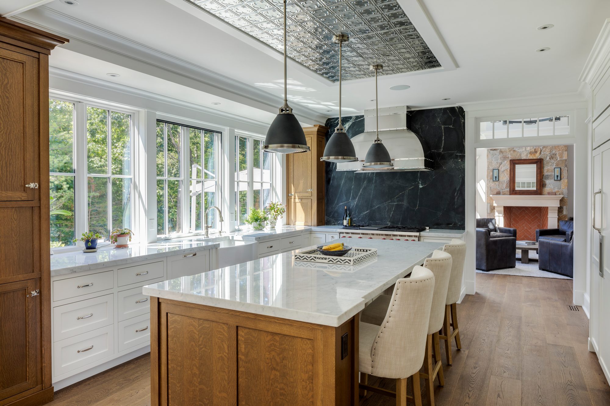 Weston Residence — chef's kitchen with marble island and pressed-tin ceiling