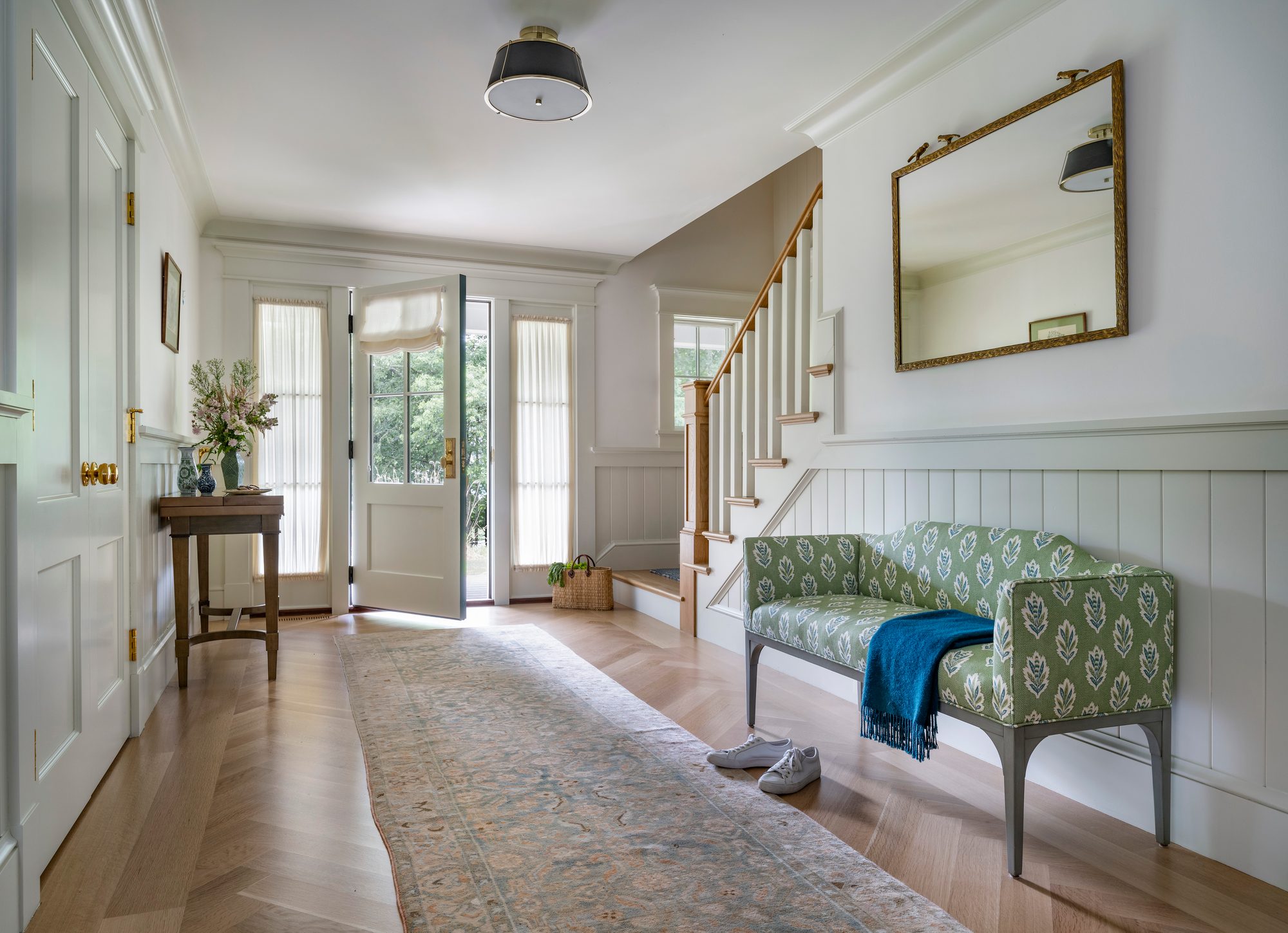 Westport Residence — entry foyer looking out through the front door, with a patterned runner