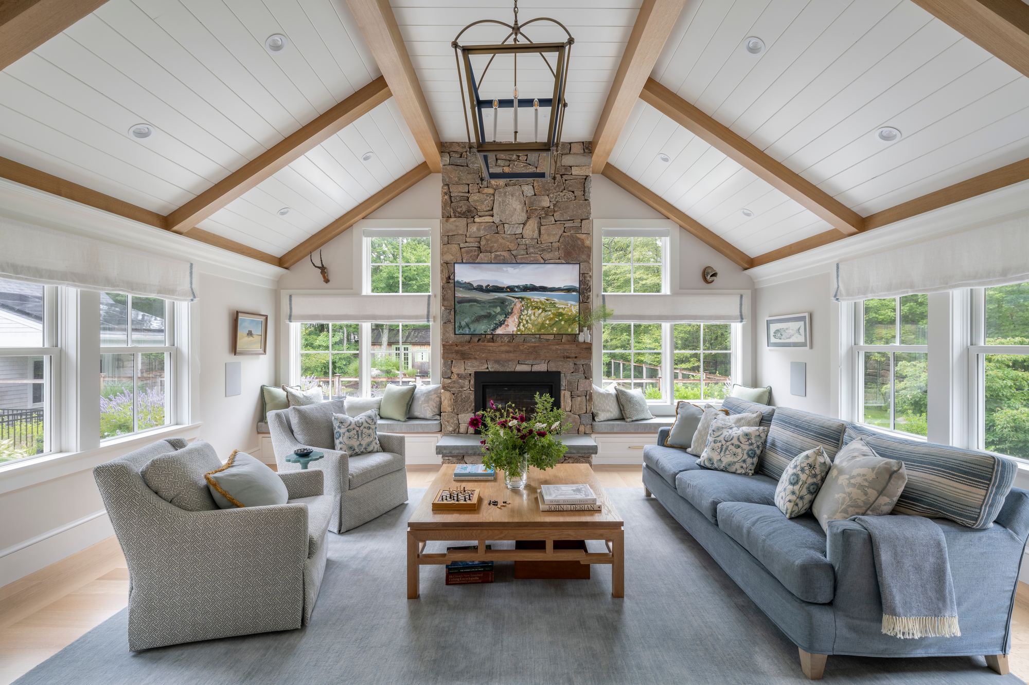 Westport Residence — living room with a vaulted shiplap ceiling, exposed beams, and a stone fireplace