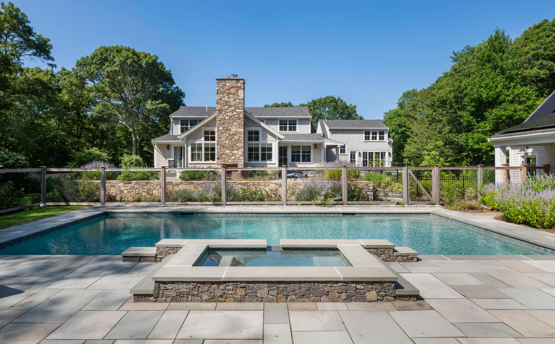 Westport Residence — pool and terrace centred on the stone chimney