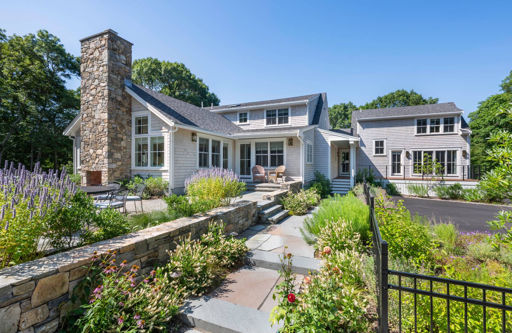 Westport Residence — rear terrace and gardens beneath the stone chimney